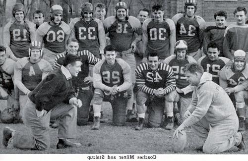 Head football coach Milner grins at his assistant coach, Wilber "Sparky" Stalcup.  During the basketball season, the men switched roles, as Stalcup was head basketball coach and Milner was the assistant coach.